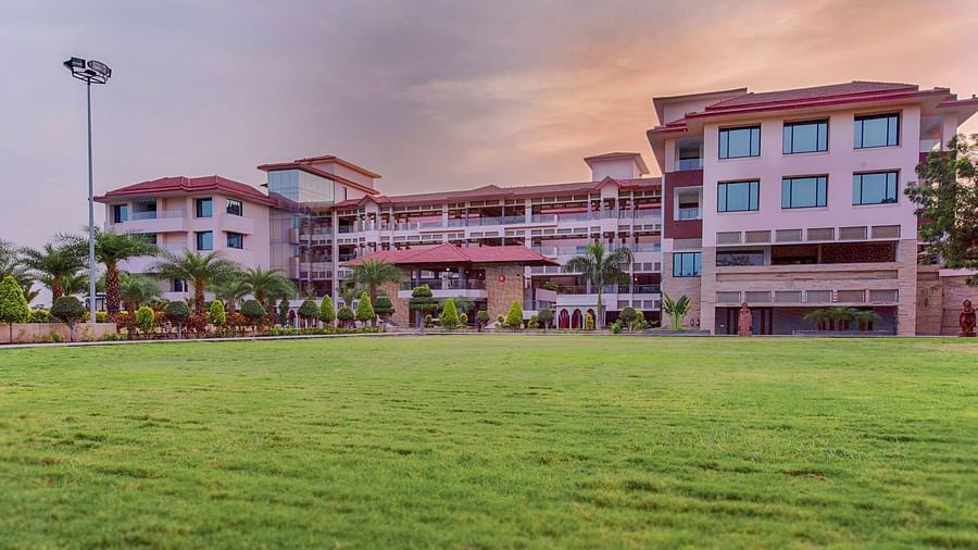 A huge lawn in front of a multi-storey building, captured after dusk - Crescent Spa & Resort, Indore