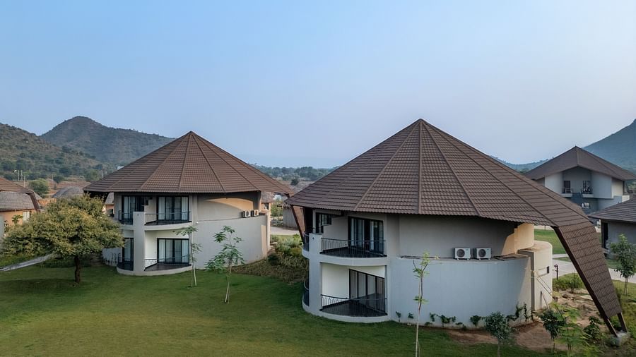 An image of two attic style villas with balconies and huge windows