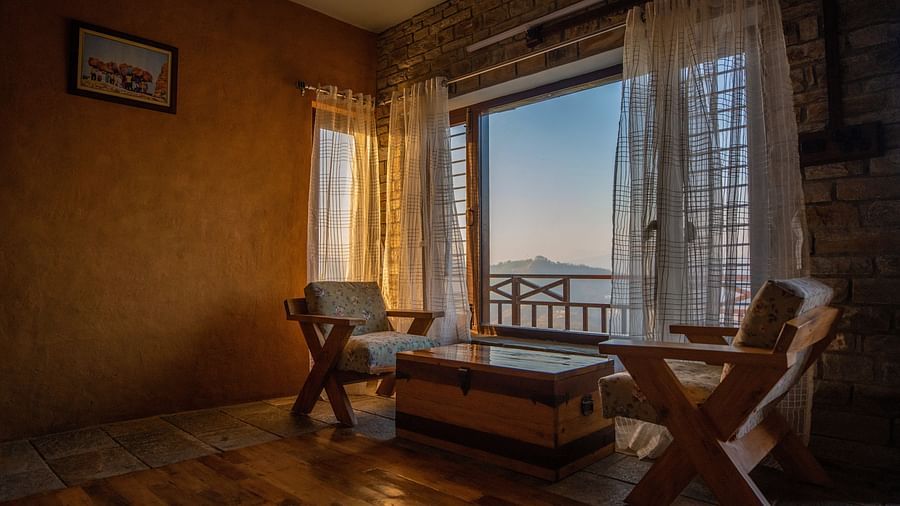 A cosy wooden room with panoramic windows, bathed in soft morning light, offering stunning views of the valley. - Blusalzz Homes The Himalayan Bungalow, Almora
