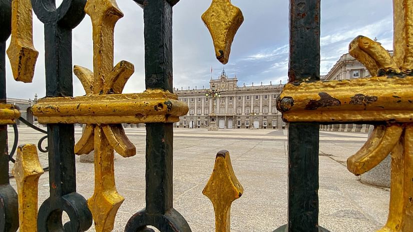 A far out view of a palace with dark clouds in the background