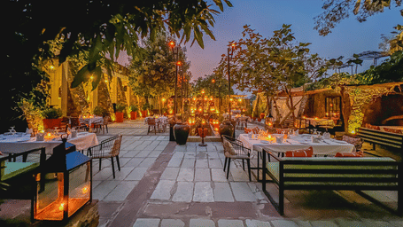 An image of an outdoor seating at the hotel with decorative lighting - Utsav Camp Sariska