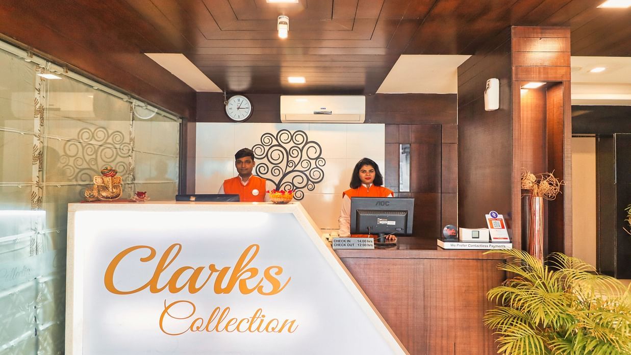 two receptionists at the reception desk at Clarks Collection Vadodara 