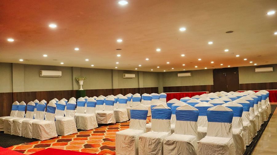 The banquet hall is set up with round seating tables at Clarks Collection, Bhavnagar