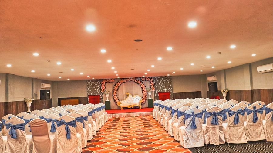 The banquet hall is set up with round seating tables at Clarks Collection, Bhavnagar