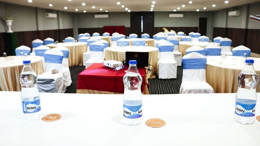 The banquet hall is set up with round seating tables at Clarks Collection, Bhavnagar