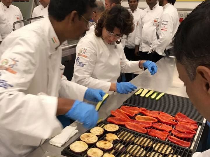 Chefs making dishes in the kitchen with different ingredients.
