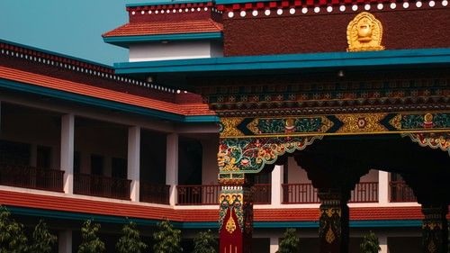 A Buddhist stupa with a golden spire against a clear blue sky