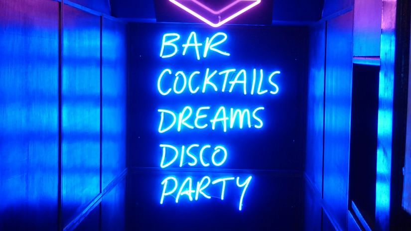 A neon signboard at a cocktail party