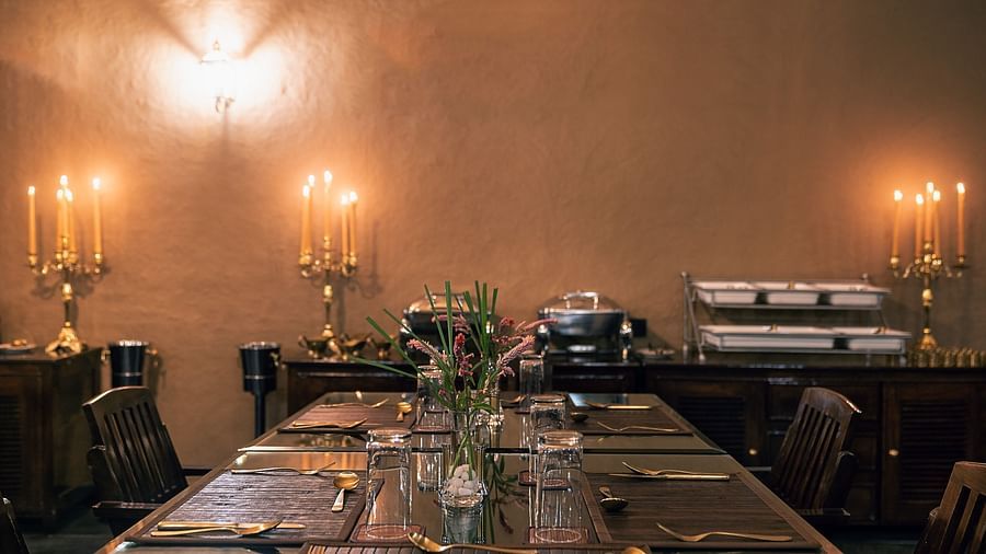 A dining area surrounded by candles at our restaurant near Haridwar - Aalia Jungle Resort & Spa