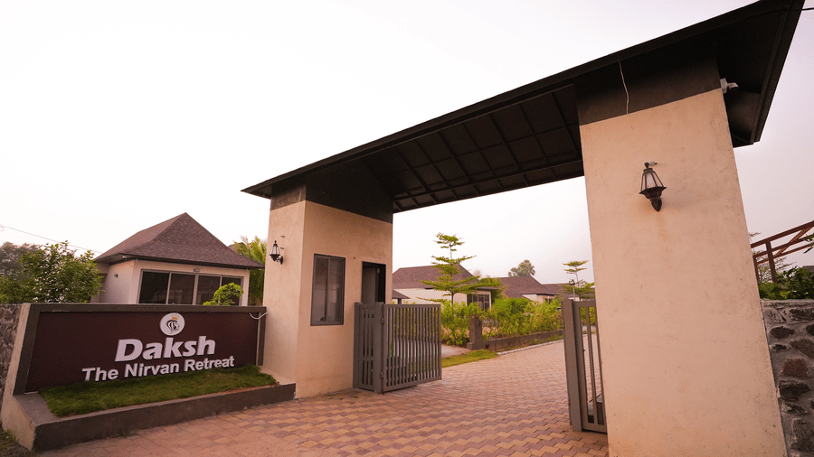 The main entrance gate of the property featuring a modern architectural canopy and a sign reading 'Daksh The Nirvana Retreat' - Daksh The Nirvana Retreat, Pavagadh
