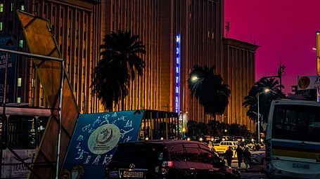 An overview Gare Centrale in Kinshasa during twilight hour with trees in view.