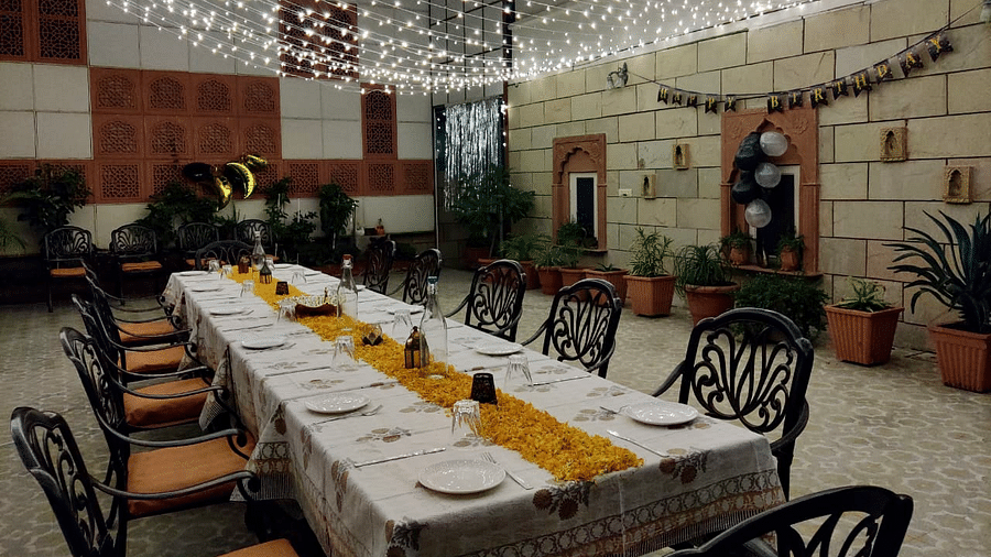 Seating arrangement with fairy lights on the top at Al-fresco Dinner at the courtyard at Suryaa Villa Jaipur