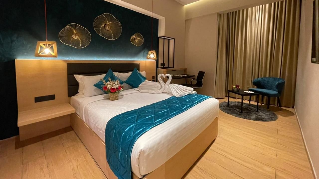 Double bed with blue sheets at Premium Room at Le Foliage by TGI, Bangalore