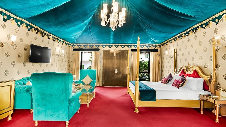 An overview of a tent with a double bed, sofas and a coffee table - Rajasthali Resort & Spa, Jaipur.