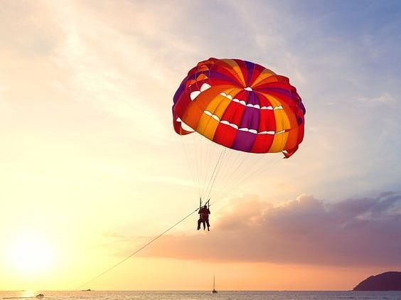 parasailing, sky view, sea, sand.