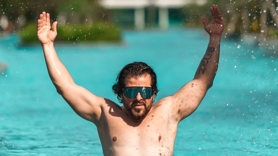 an image of a person in the pool posing for a picture - Rhythm Kumarakom