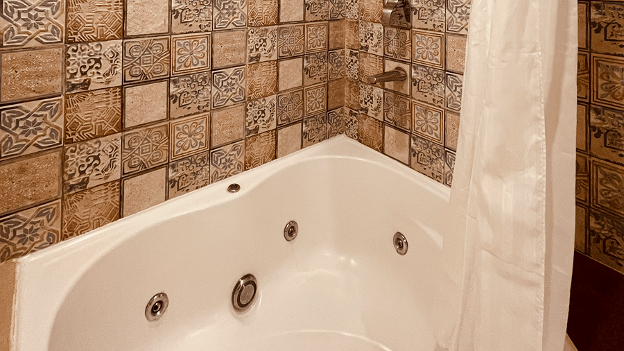 The Jacuzzi tub with white shower curtains hanging beside it at the Senses Hotel.