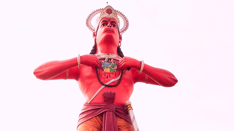 A massive structure of the hindu deity Hanuman with a white background