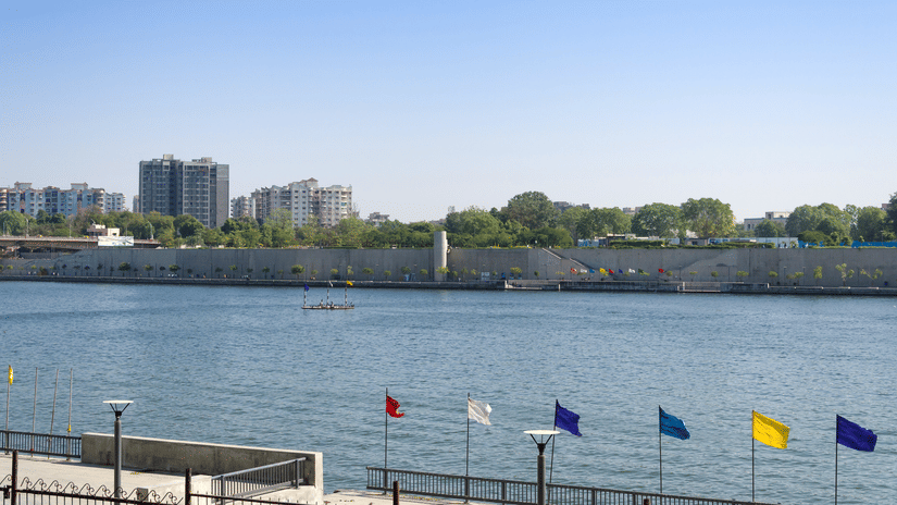 Sabarmati Riverfront promenade with river view flags and cityscape in Ahmedabad
