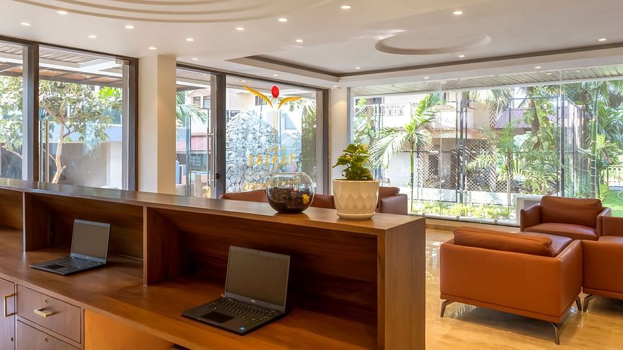 Overview of the lobby with a reception desk and sofas in the background - The Tanisi Hotels & Resorts, Goa