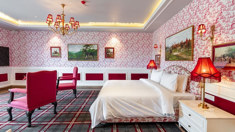 alt-text A room with a large bed and two comfy chairs in front of it  - The Manor Luxury Hotel, Shimla