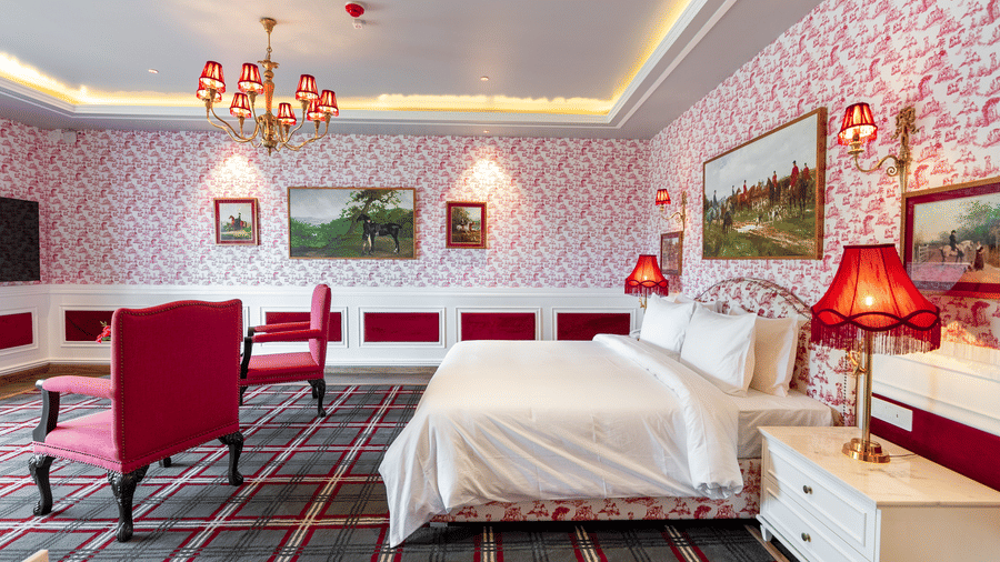 A room with a large bed and two comfy chairs in front of it  - The Manor Luxury Hotel, Shimla