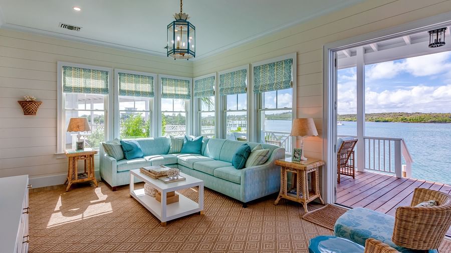 Lounge with plush seating, panoramic windows, and a chandelier | Abaco Inn