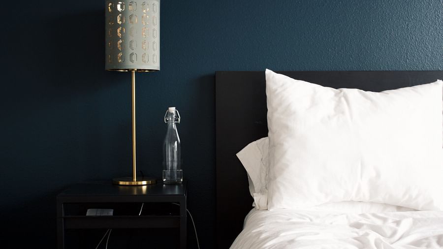 Rosetum - Lamp on a side table next to a bed