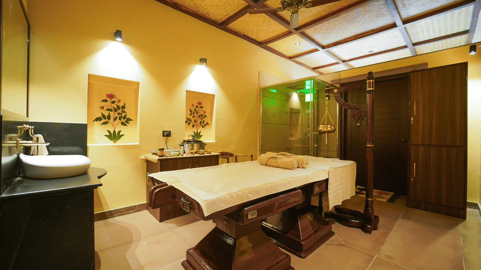 A well-designed spa treatment room at Aamaghati Wildlife Resort featuring twin massage beds, soothing lighting, and peaceful interiors for ultimate guest rejuvenation.