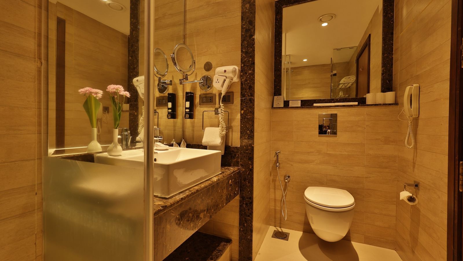 Standard Tropic Green Room with Partial Mountain View bathroom showcasing a vanity area, toilet, and premium finishes at Fragrant Nature Munnar