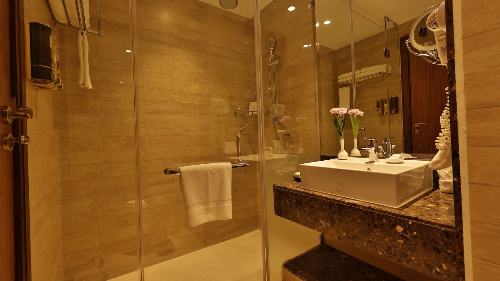 Standard Tropic Green Room with Partial Mountain View room bathroom with glass shower enclosure, vanity counter, and modern fixtures at Fragrant Nature Munnar