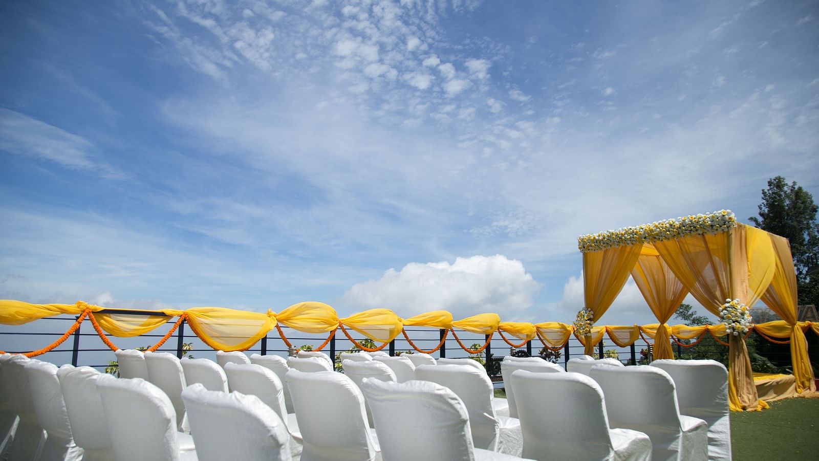 An image of the open banquet space with chairs and decoration - Great Trails Yercaud by GRT Hotels