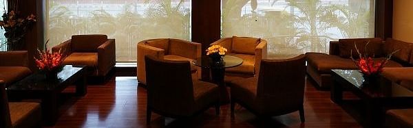 sofa arranged against a large window at Shervani Nehru Place, New Delhi