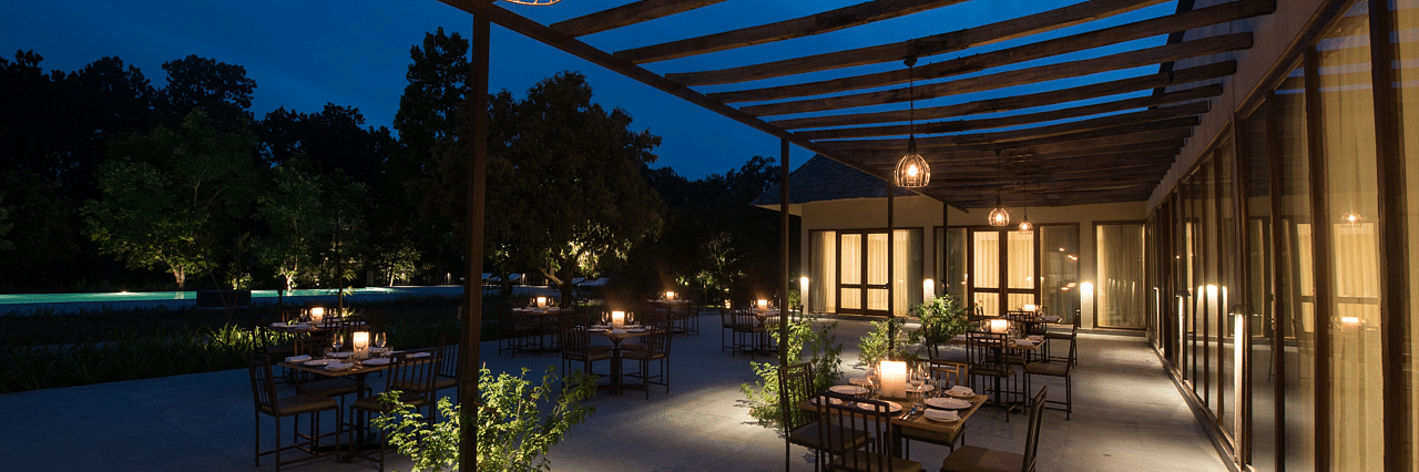 Outdoor dining arrangement at a restaurant at Saraca Resort & Spa Corbett