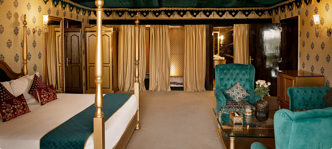 Side view of a room with a bed and a seating area in front at Rajasthali Resort & Spa Jaipur.