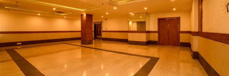 Another angle of a banquet hall with a marble floor, showcasing the expanse of the room and its warm lighting.