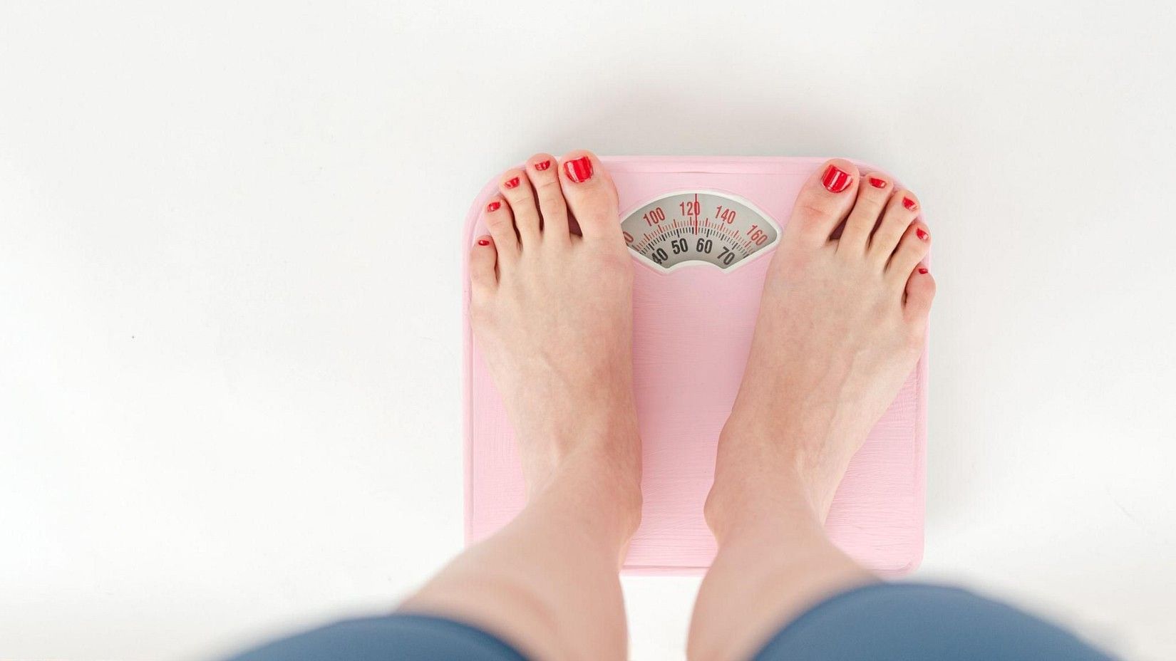 A person standing on a weighing machine