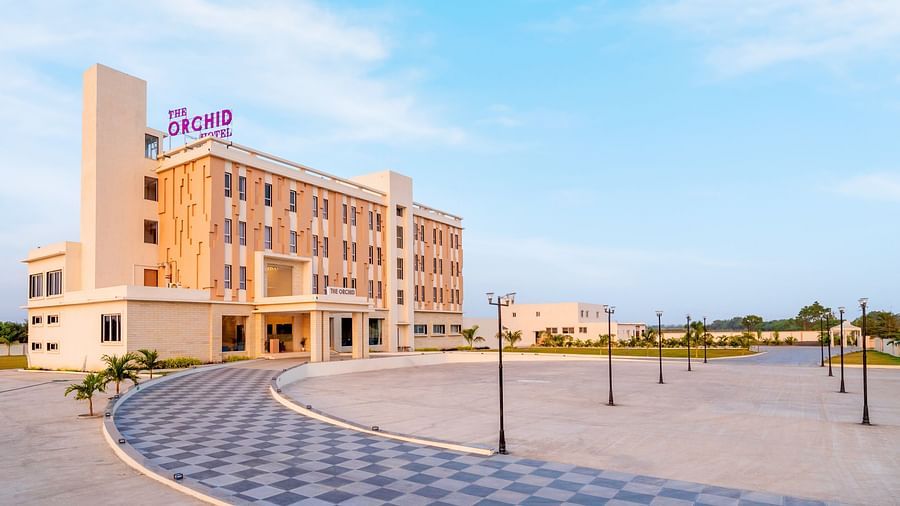 Facade view of The Orchid Hotel, Jamnagar with blue sky in the background