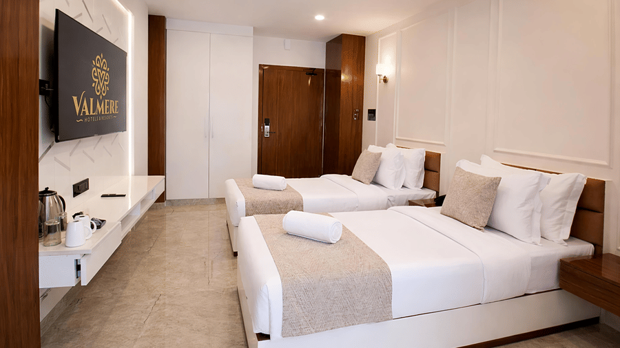 A Premium Twin Room at Valmere Chery Blossom Suites with 2 twin beds, a flat-screen television, and a wooden door with an electronic locking system.