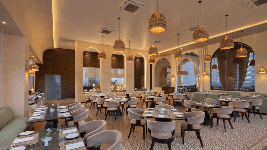 A dining space with several chairs and tables | Essentia Luxury Hotel and Convention, Nagpur