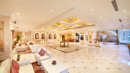 An image of a lobby featuring multiple seating areas and table placed at the centre of the lobby at Accord Metropolitan