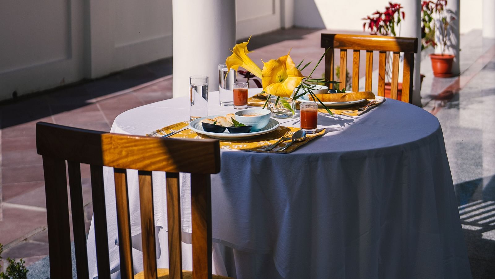 A table for two, neatly set for dining on the balcony at BluSalzz Villas - The Green Roof, Bhimtal.