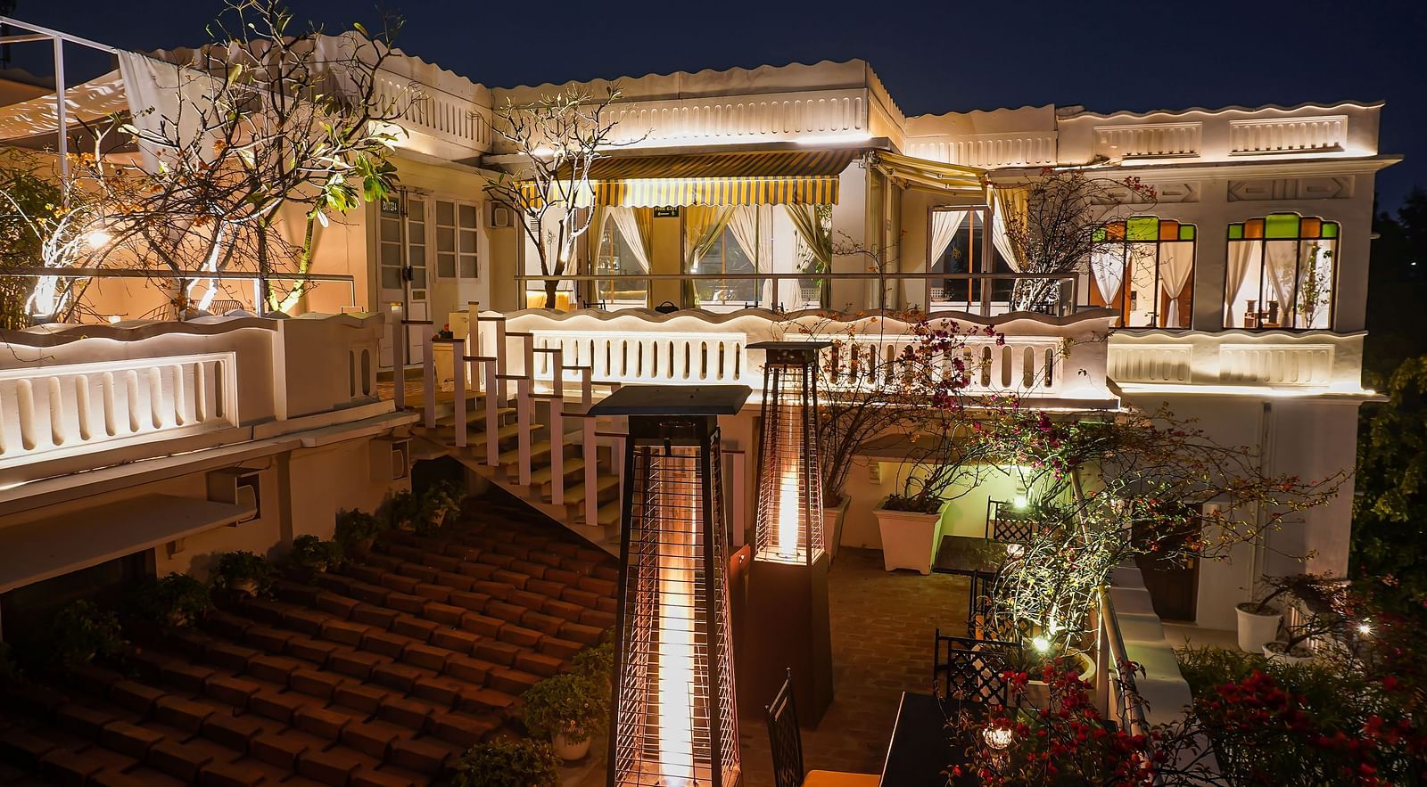Exterior of well-lit Saraca Bar at Saraca Hotel, Lucknow at night