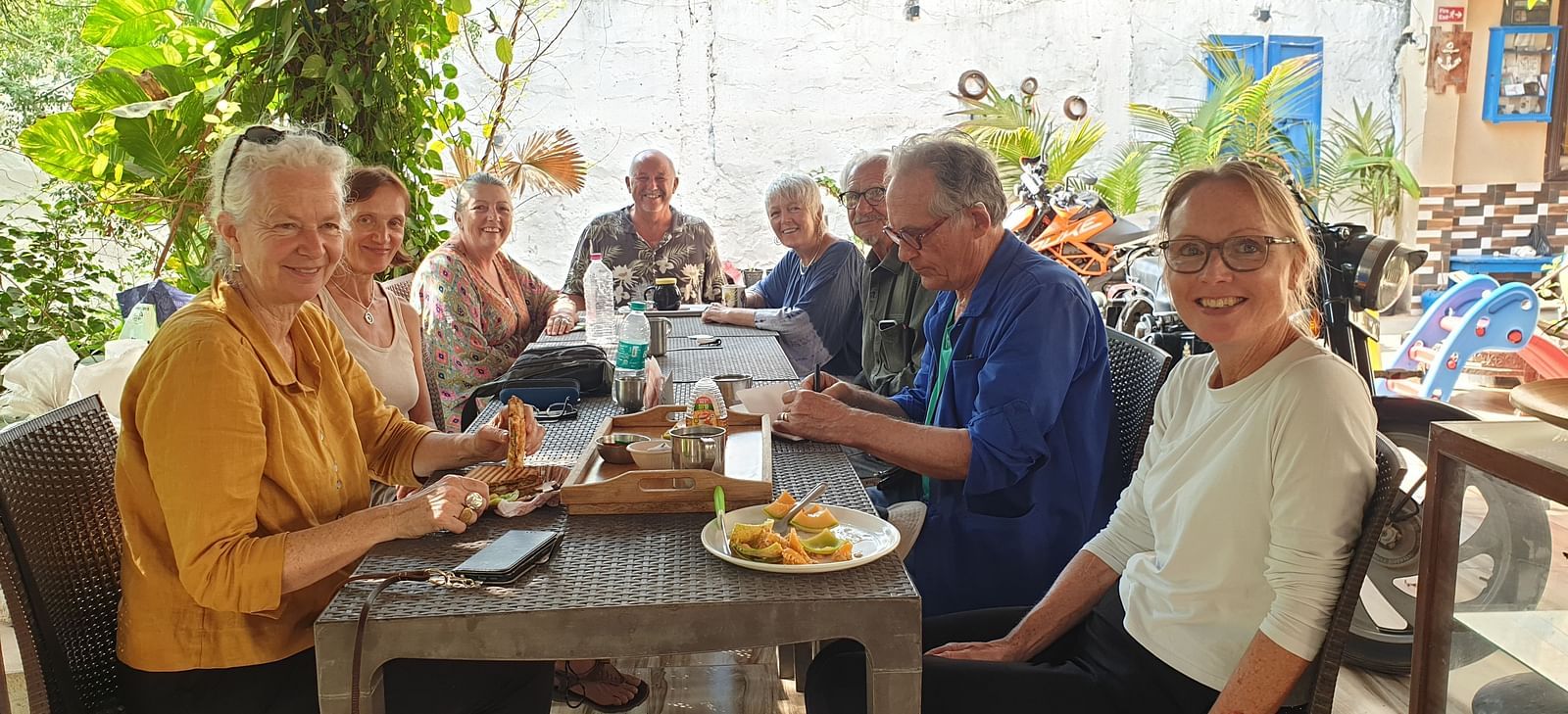 A group of tourists having a good time as they are seated on a dining table at the Dream Vision Guest House.