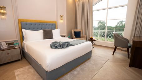 Stylish room with king bed and scenic view at Miros Hotels.