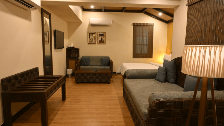 Sitting area at The Richmond Puducherry with couches, table and lamps.