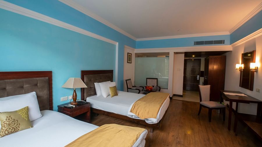 Mastiff Grand, Manali Manali		 A room with twin beds, a TV, desks, chairs, mirror and a big balcony - Mastiff Grand,
