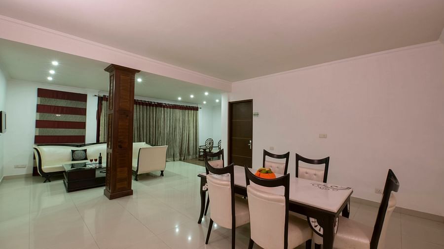 A spacious seating area with sofas tables and chairs - Mastiff Grand Manali