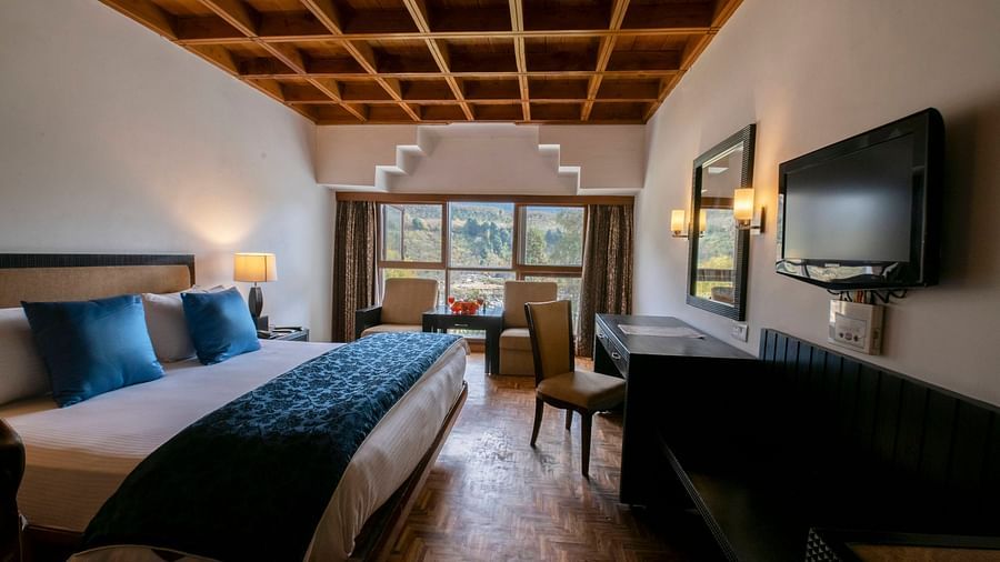 a view of Duplex at Mastiff Grand, Manali featuring wooden furnishing and comfy bed