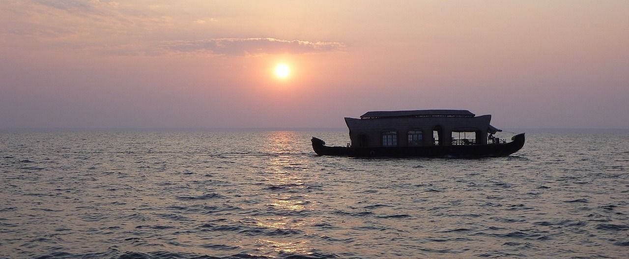 Image of a cruise sailing across the river during sunset.